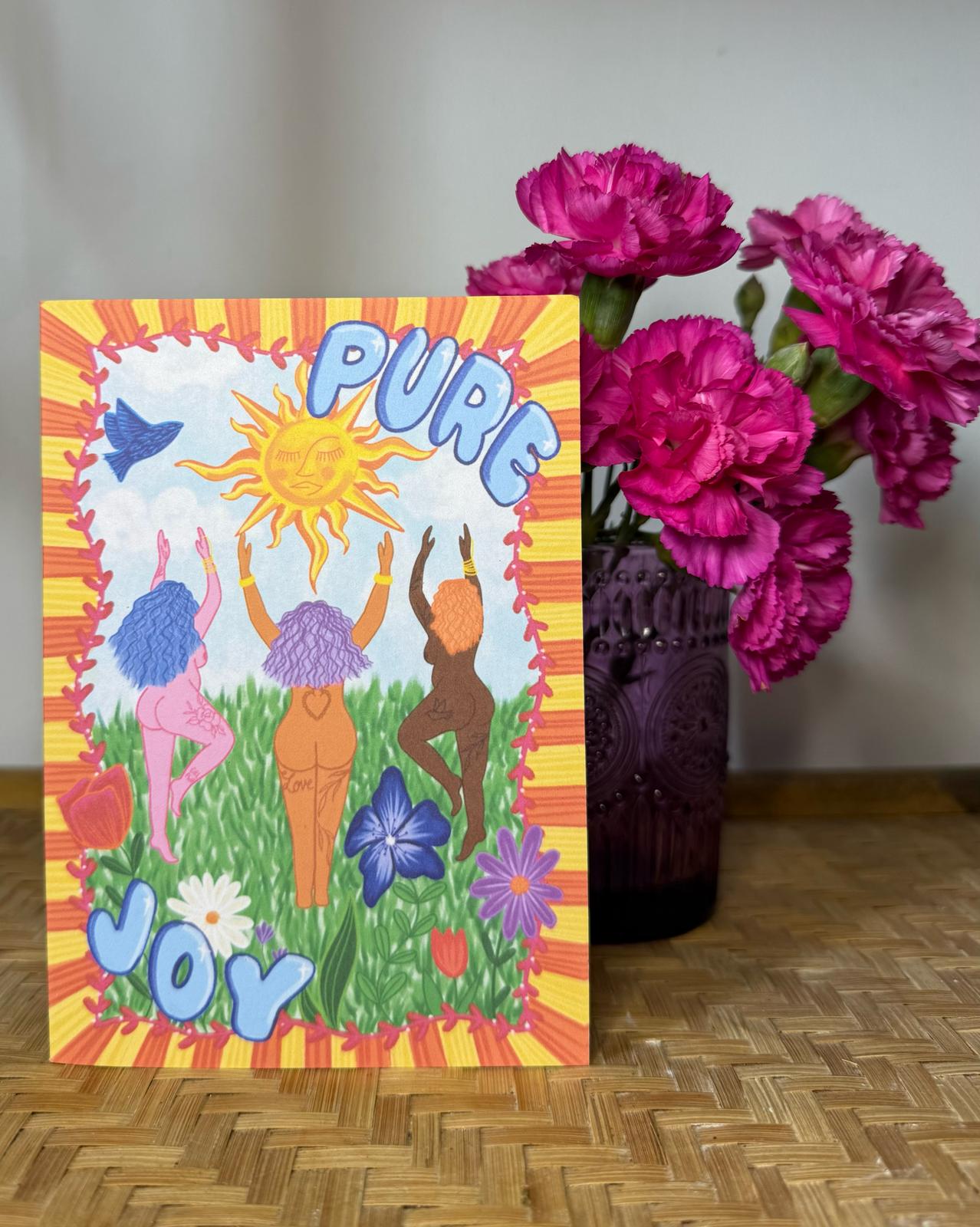 Colorful card with 'PURE JOY' text and illustrations of people dancing, flowers, and a sun.